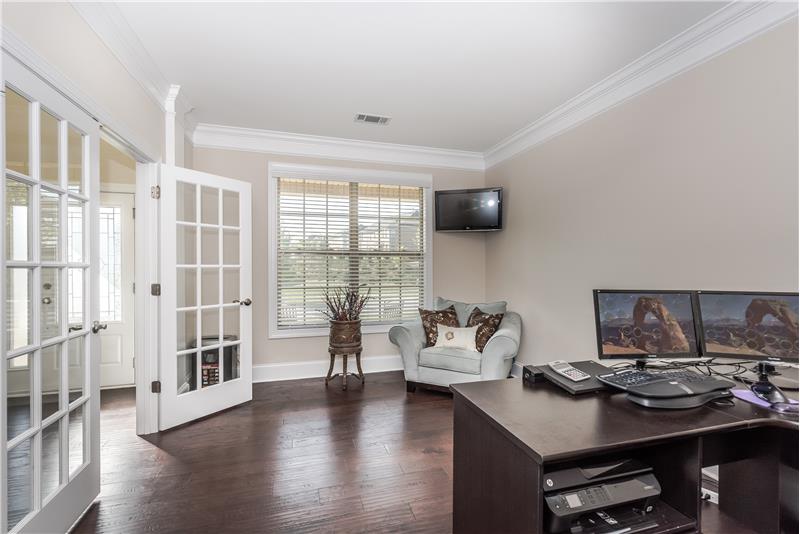 Bright and sunny home office features hardwood floors, crown molding, double French doors for privacy.