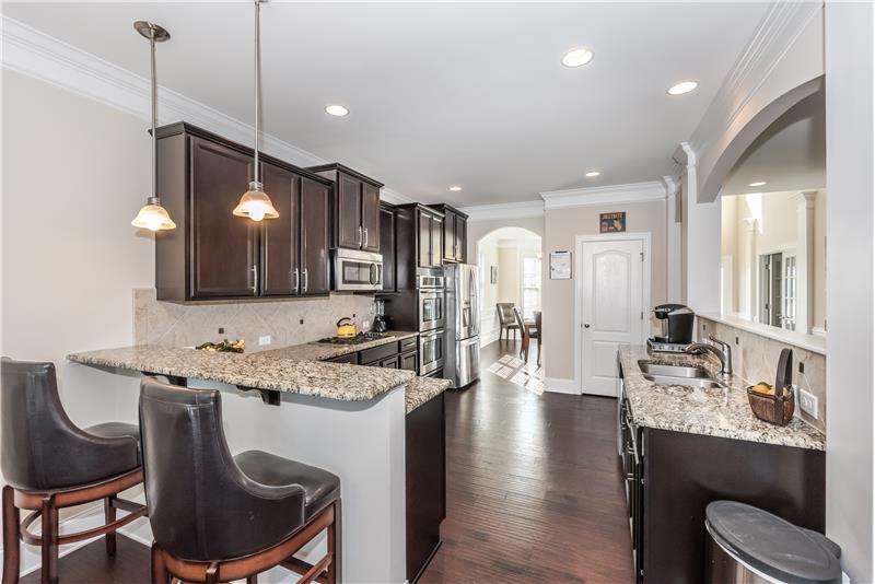 Cook's kitchen includes granite, hardwood floors, stainless steel appliances, pantry, breakfast bar