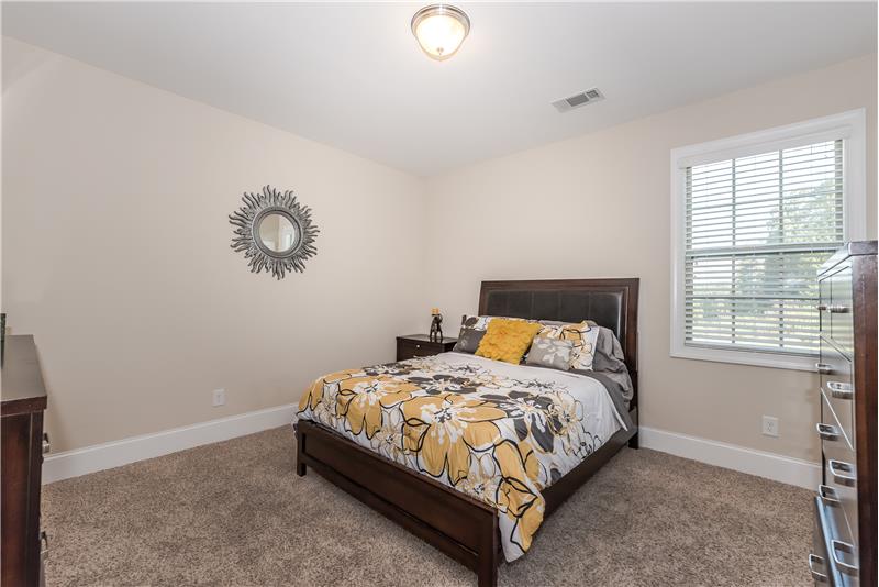 First floor bedroom with adjacent full bath and walk-in closet. Perfect for guests or family members who have trouble navigating