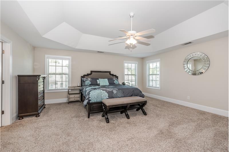 Serene and spacious master suite with room for king-size bed, larger dressers, sitting area.
