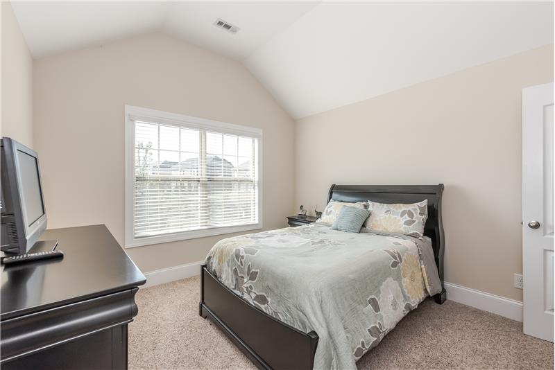 One of three additional bedrooms on the home's second floor, all with neutral carpet and paint, walk-in style closet. This one f