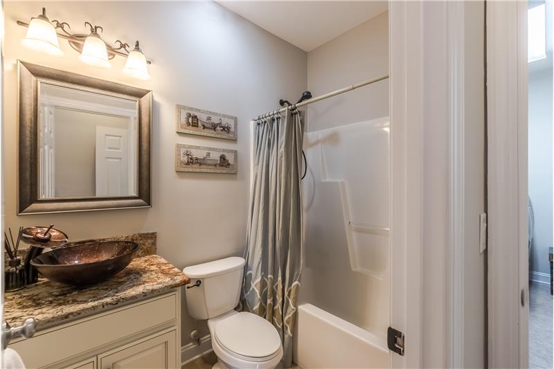 Main floor bathroom upgraded with granite counter, designer vessel sink, rubbed bronze fittings.