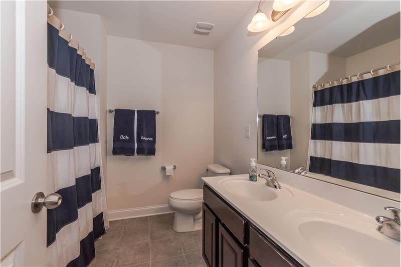 Second floor hall bath features a double sink vanity.