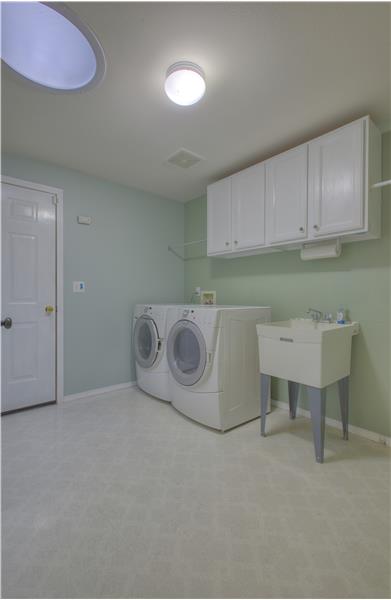 Your laundry room offers ample space, cabinetry, and access to your sizeable two car garage. 