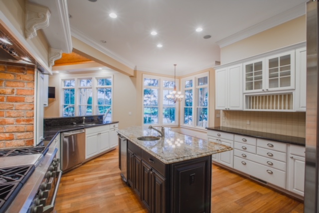 Kitchen with 6 burner gas stove.