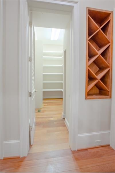Walk-in pantry with wine rack.