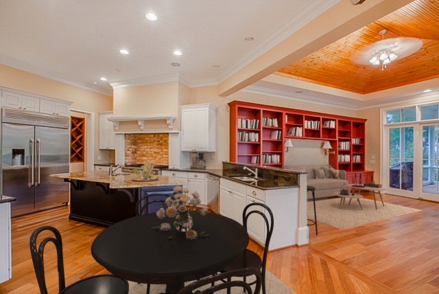 Open kitchen, dining, and family room with access to screened-in porch.