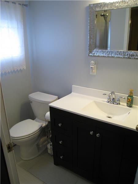 Newly Renovated Bathroom with Tiled Shower Stall