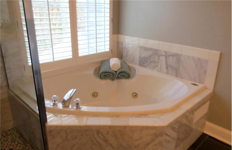 Jetted Jacuzzi Tub with Marble Surround in Master Bathroom