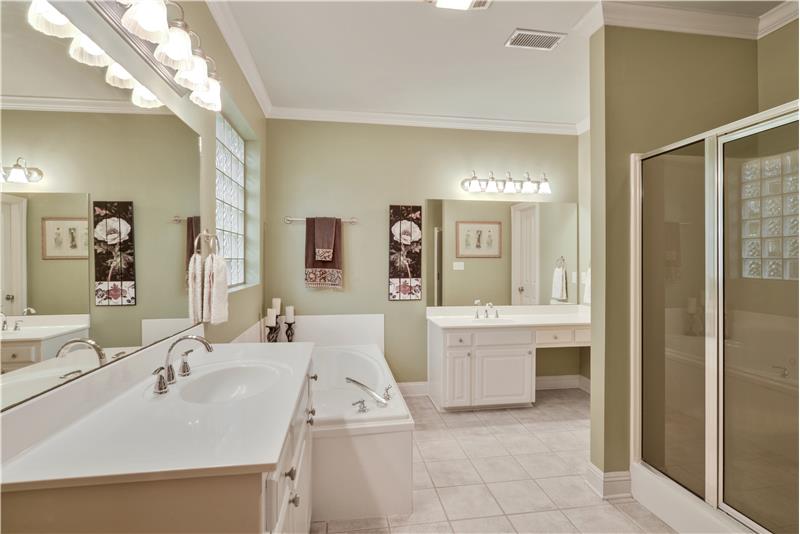 Master bath has newly install faucets, his/her vanities, jetted tub and separate shower