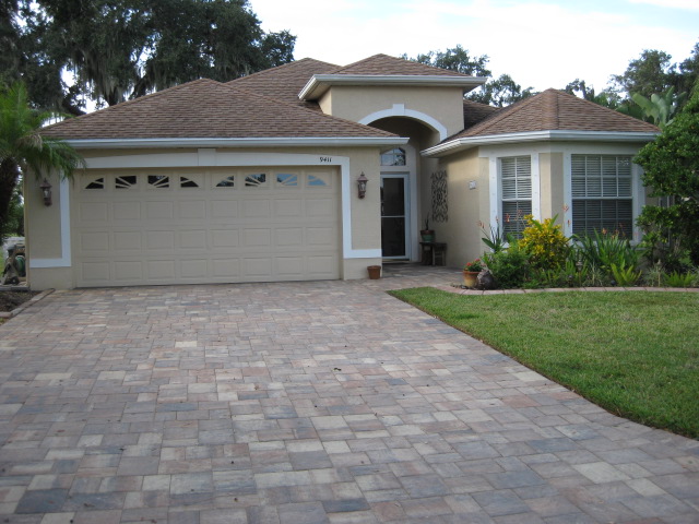 Front of home with paver driveway