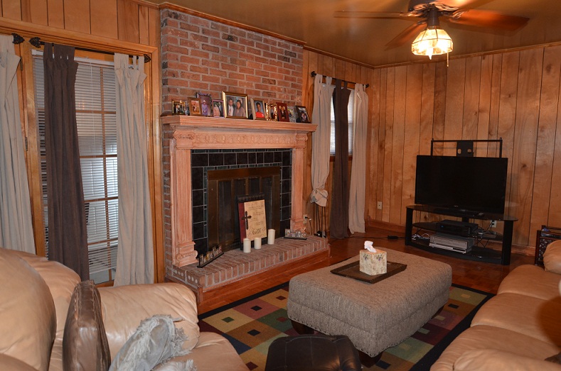 Cozy den, with a wood burning fireplace, that opens up from the kitchen.