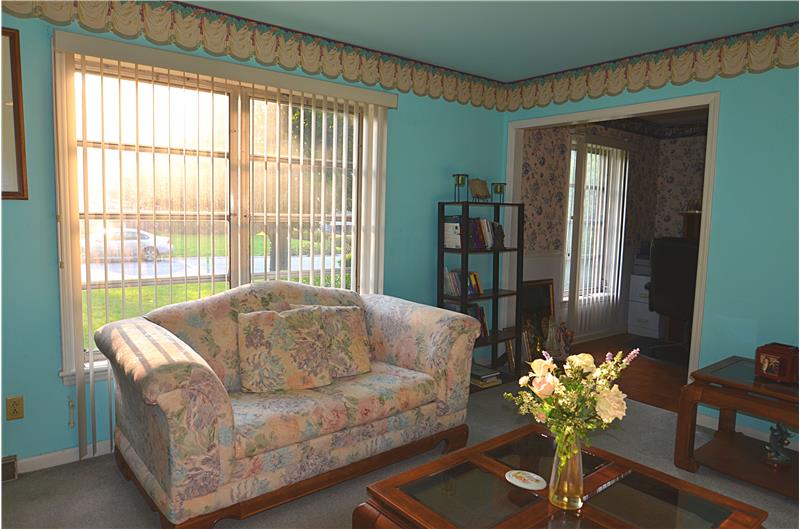 Enjoy the natural sunlight in this warm and welcoming formal living room.