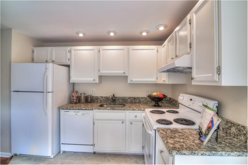 Upgraded kitchen with granite and recessed lighting