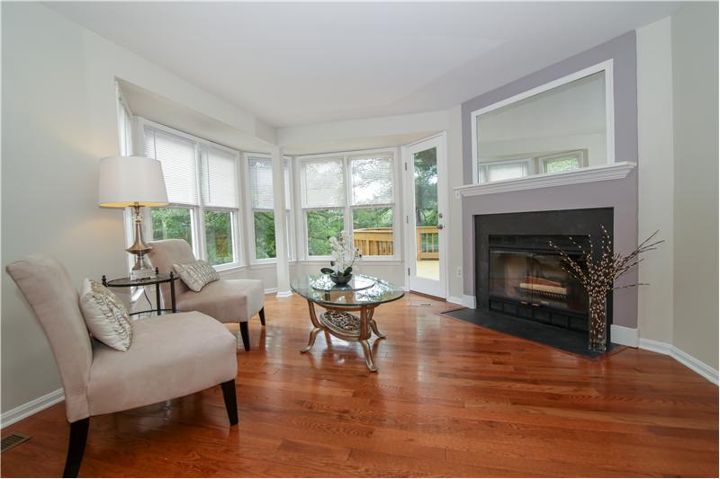 Windows galore, a cozy corner fireplace and new door to the deck