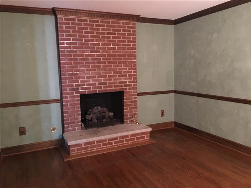 Den with brick-hearth fireplace