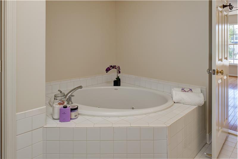 private corner soaking tub in master bath