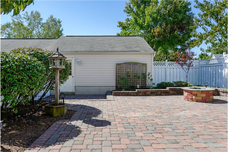 Spacious fully fenced rear yard with fire pit 