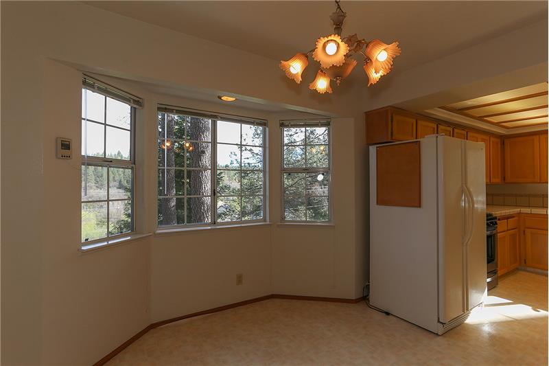 Breakfast Nook with Bay Window. A great place to sip coffee or tea while watching the birds popping and in and out of the birdho