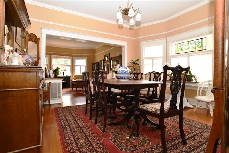 Formal dining room can seat 6-10 comfortably. Authentic old light fixture is above the table.