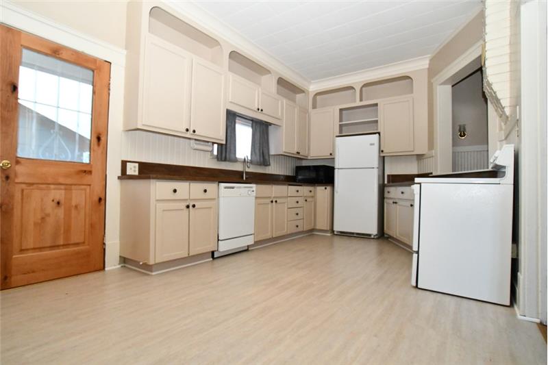 Kitchen with new Corian countertops and vinyl flooring
