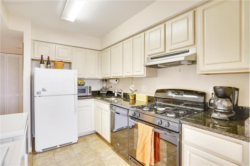 Kitchen with updated cabinetry, gas stove and granite counters