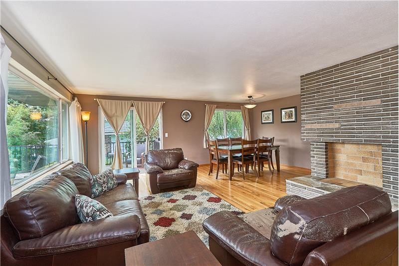 Light and Bright Formal Living Room and Dining Room. Gleaming Hardwood Floors and Lovely Brick, Wood Fireplace. Newer Light Fixt
