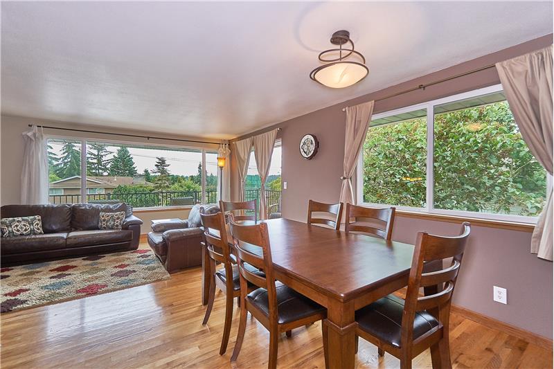 Formal Dining Room with Gleaming Hardwood Floors, Newer Vinyl Windows and Slider leading to the Front, Wrap Around Deck.