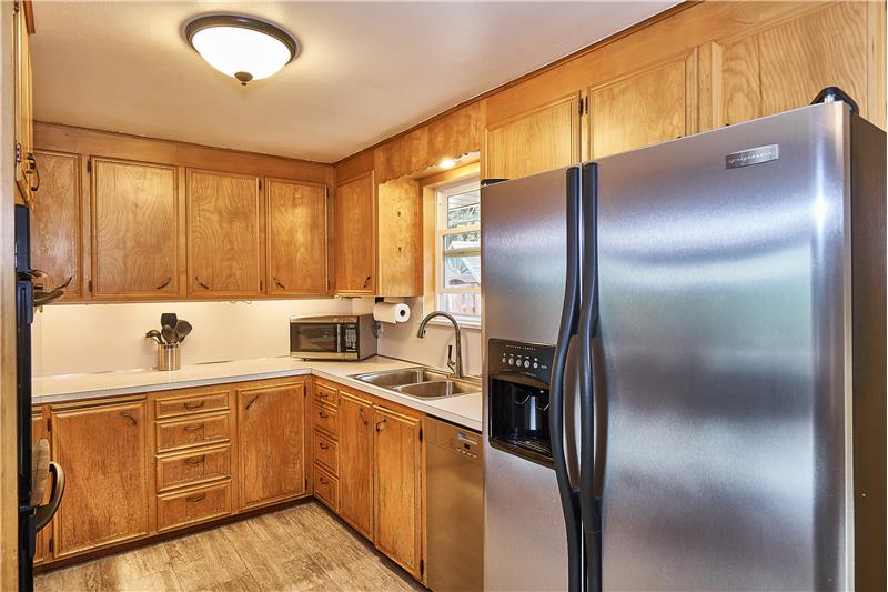 Lovely Kitchen with Dual Ovens, Newer Tile Floors and 5 Burner Gas Stove. Stainless Steel Refrigerator and Dishwasher.