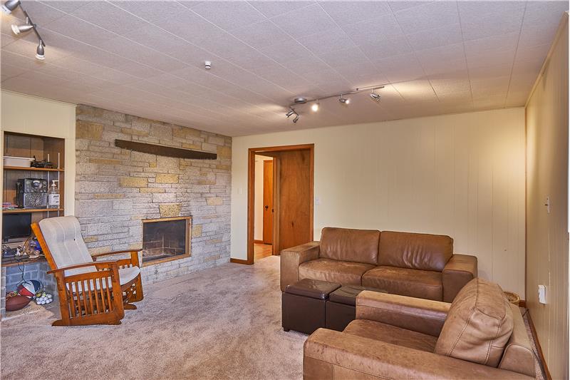 Huge Family Room Downstairs with Brick Fireplace. New Trim and Carpet Downstairs.