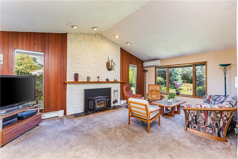  Cozy Family Room with Brick Fireplace, Wood Burning Stove and Vaulted Ceilings.