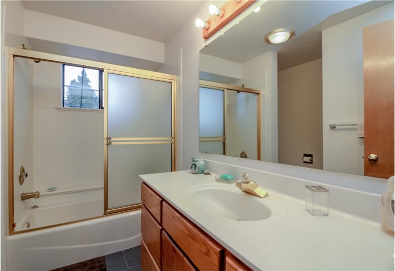 Guest bath.  Tile floor, linen closet
