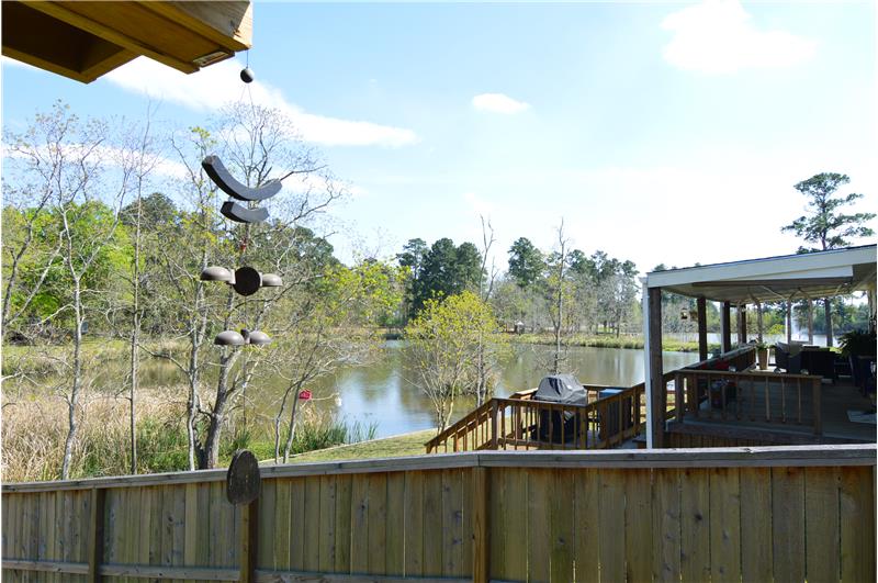 Welcome to your new home with a lake view from your covered wood deck!