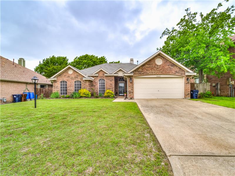Ranch-style house with a garage and a front yard