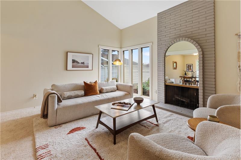Spacious Living Room with high cathedral ceilings and a fireplace.
